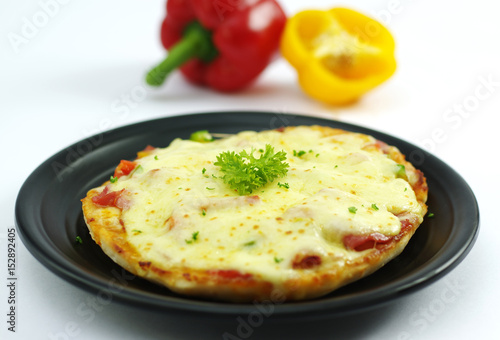 Chicken pizza in korean style with bell pepper on black dish