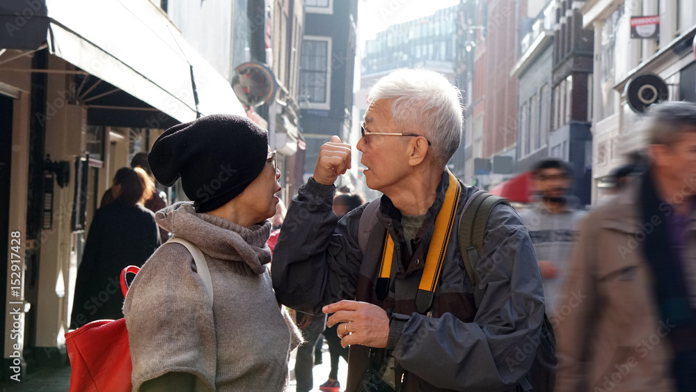 Asian senior couple lost in Europe. Travel after retirement and get confuse during the trip Asian senior couple lost in Europe. Travel after retirement and get confuse during the trip