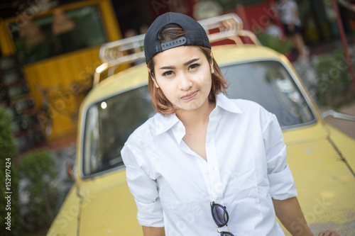 Asian woman in vintage style and car.
