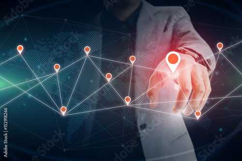 Businessman touching virtual private network on the touch screen world map on screen with connecting light between continents
