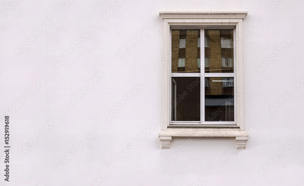 Beautiful window on white plaster wall