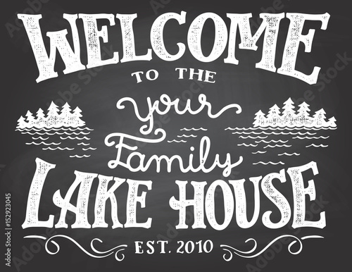 Welcome to the your family lake house chalkboard sign. Replace YOUR with the surname you need. Hand-drawn typography sign on blackboard background with chalk