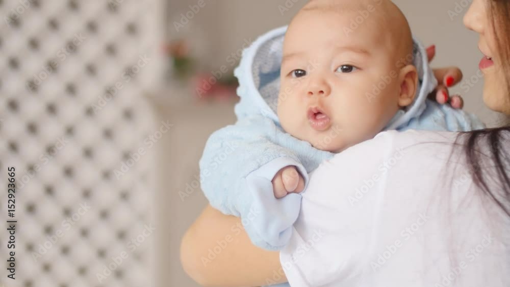 Cute Asian baby in mother arms Cute Asian baby in mother arms