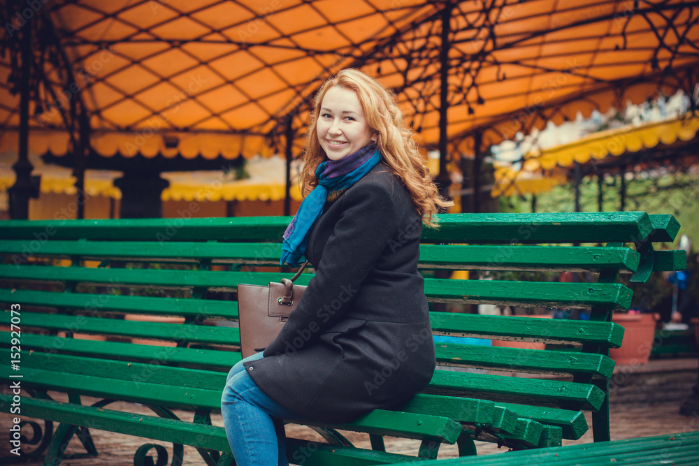 Woman in black coat walk in Europe streets with a good mood. Funny girl with light redhead in center of city Woman in black coat walk in Europe streets with a good mood. Funny girl with light redhead in center of city