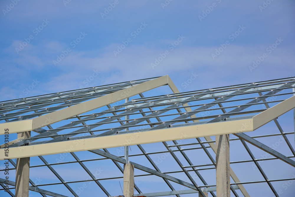 Naklejka premium Home roof steel structure on blue sky background.