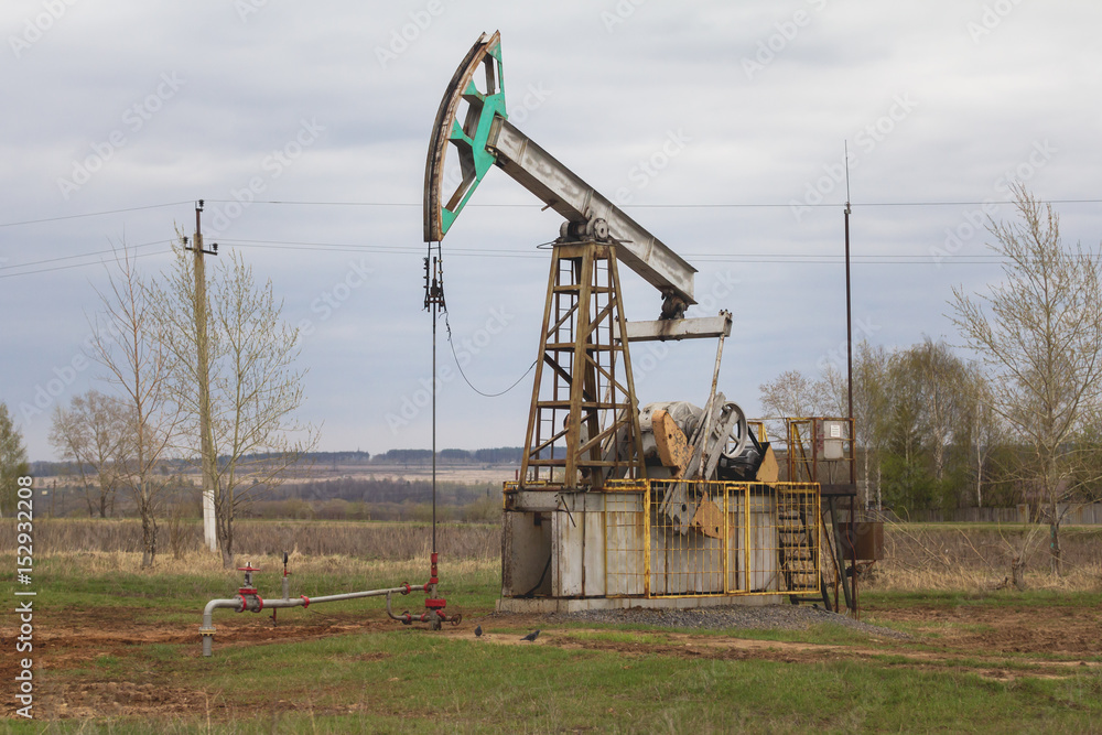 Oil pump near highway in Tatarstan, Russia Oil pump near highway in Tatarstan, Russia