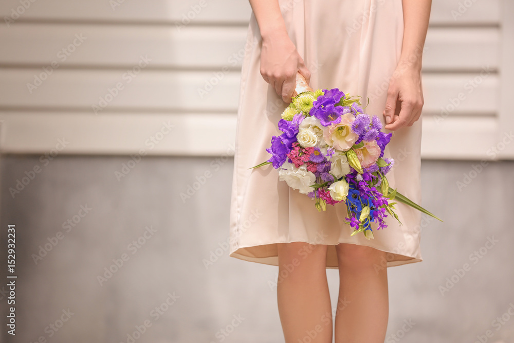 Woman holding bouquet of beautiful flowers