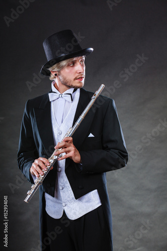 Elegantly dressed musician holding flute