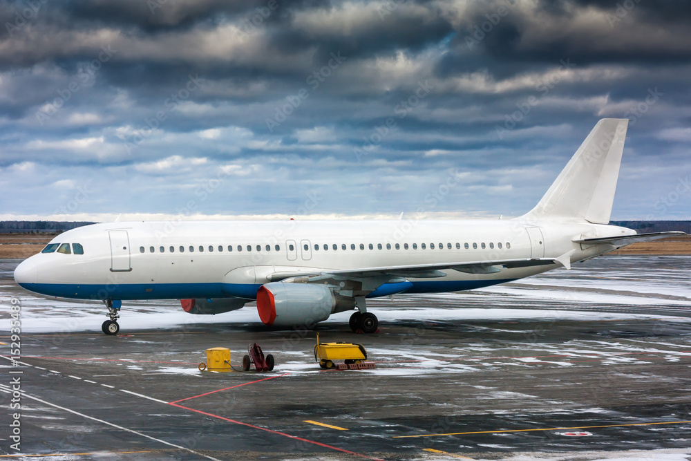Passenger airplane with shrouded engines at the airport apron Passenger airplane with shrouded engines at the airport apron
