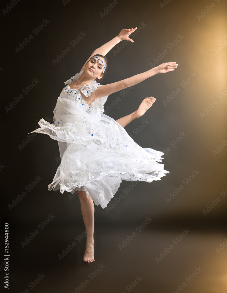 Fototapeta premium Young beautiful ballerina on dark background