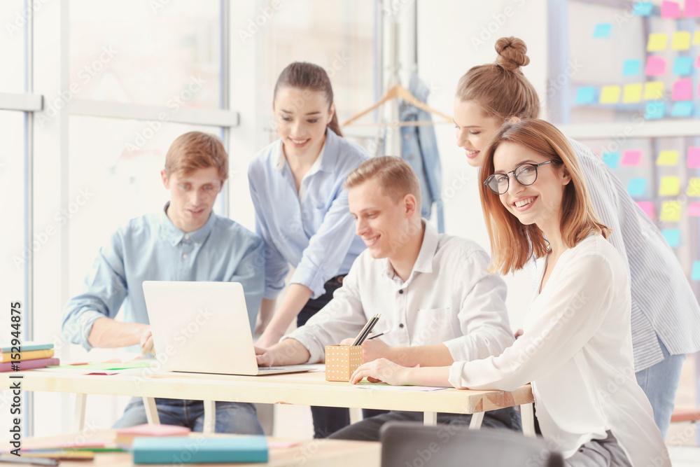 Team of young marketing managers discussing issues in office