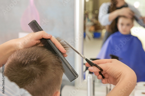 Cute little boy in hairdres...
