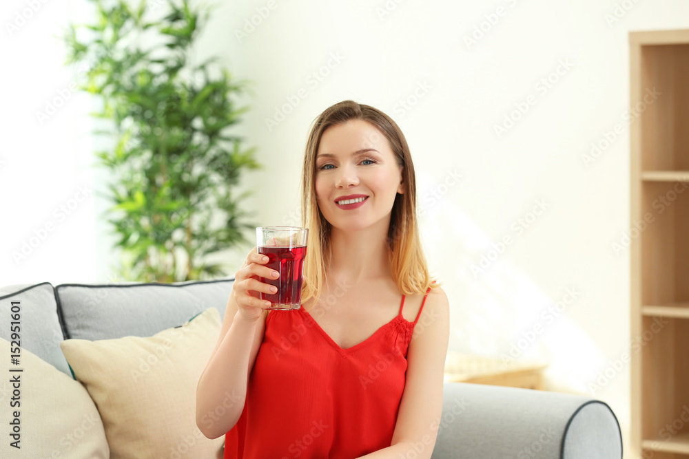 Beautiful woman with glass of fresh juice at home Beautiful woman with glass of fresh juice at home