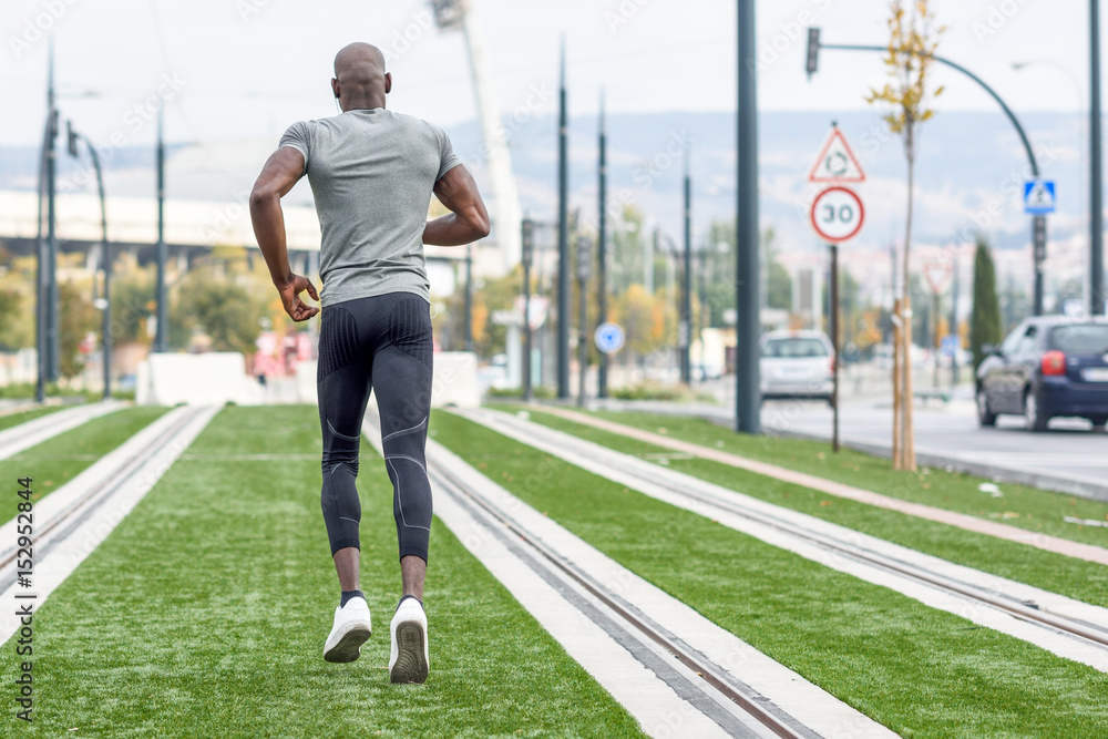 Attractive black man running in urban background