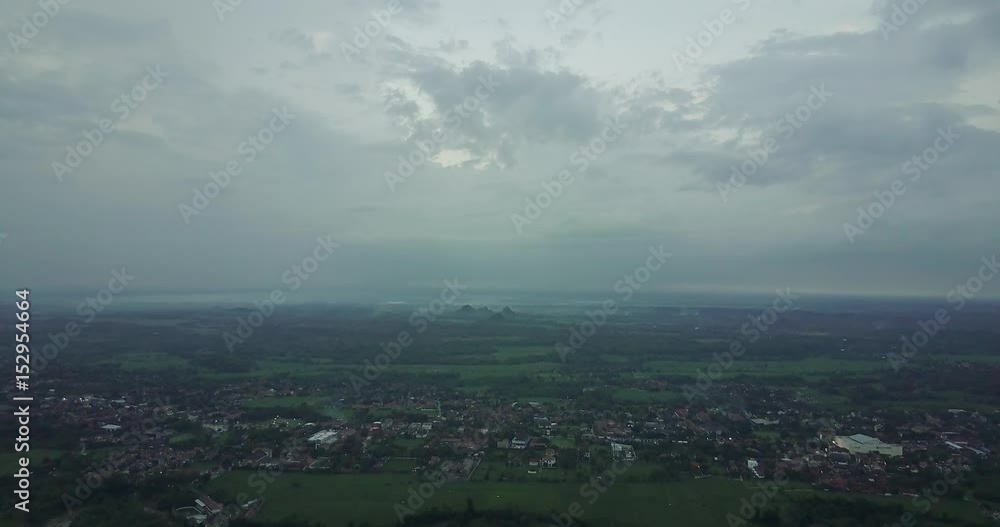 Beautiful aerial view of village houses and rice field at dusk time with cloudy sky in Majalengka, West Java, Indonesia. Shot in 4k resolution Beautiful aerial view of village houses and rice field at dusk time with cloudy sky in Majalengka, West Java, Indonesia. Shot in 4k resolution