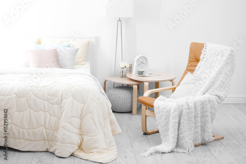 Chair near comfortable bed ...