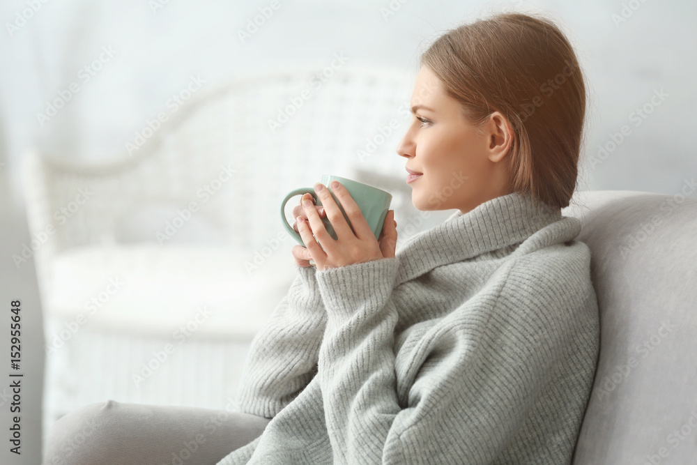 © Africa Studio - Beautiful young woman drinking tea while resting at home