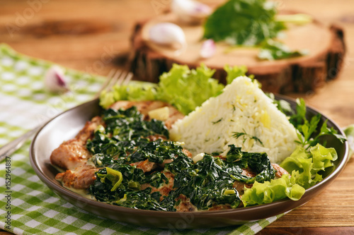 Grilled pork tenderloin with spinach sauce and boiled rice.