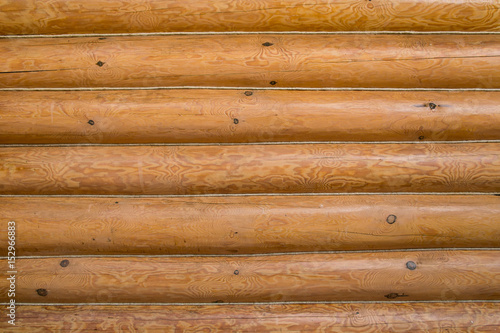 Wooden wall of a log house. Log Cabin Or Barn Unpainted Debarked Wall Textured Horizontal Background With Copy Space