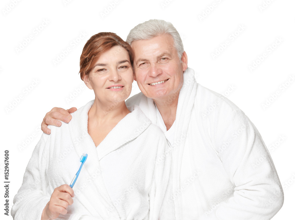 Senior woman with toothbrush and her husband on white background Senior woman with toothbrush and her husband on white background