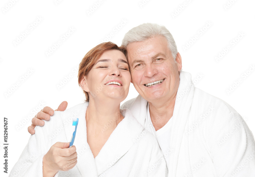 Senior woman with toothbrush and her husband on white background Senior woman with toothbrush and her husband on white background