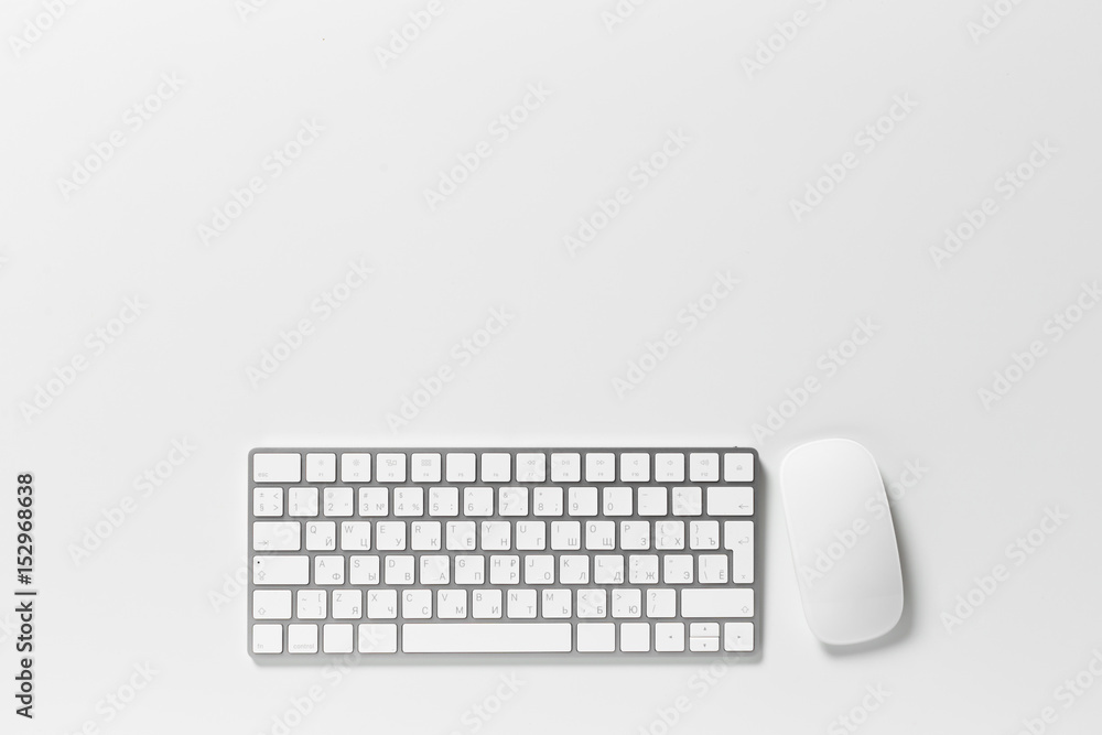 Computer keyboard and mouse on top of white desktop Computer keyboard and mouse on top of white desktop