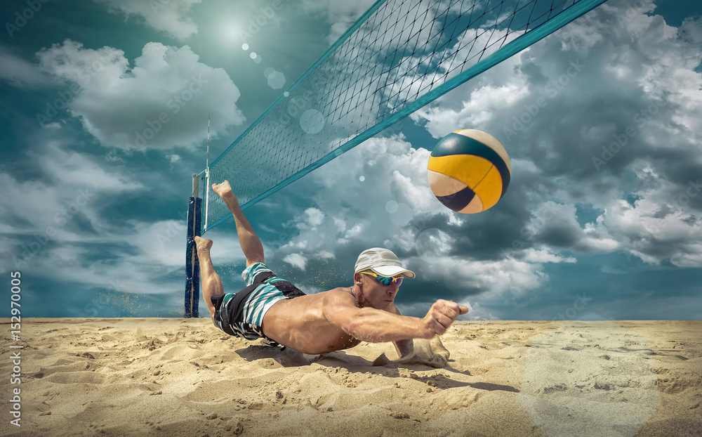Obraz premium Beach volleyball player in action at sunny day under blue sky.