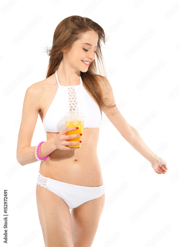 Beautiful young woman in swimsuit drinking juice on white background Beautiful young woman in swimsuit drinking juice on white background