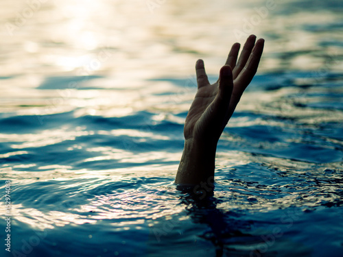 Drowning victims  Hand of drowning man needing help. Failure and rescue concept.