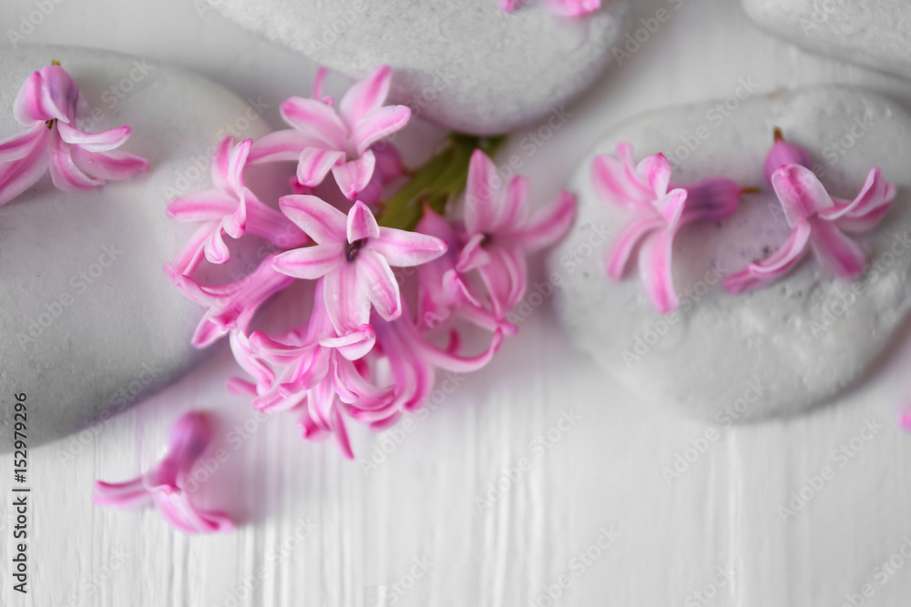 Spa stones and hyacinth on wooden table Spa stones and hyacinth on wooden table