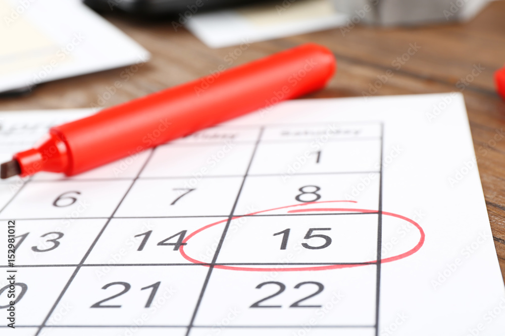 Marked calendar on table. Tax concept Marked calendar on table. Tax concept