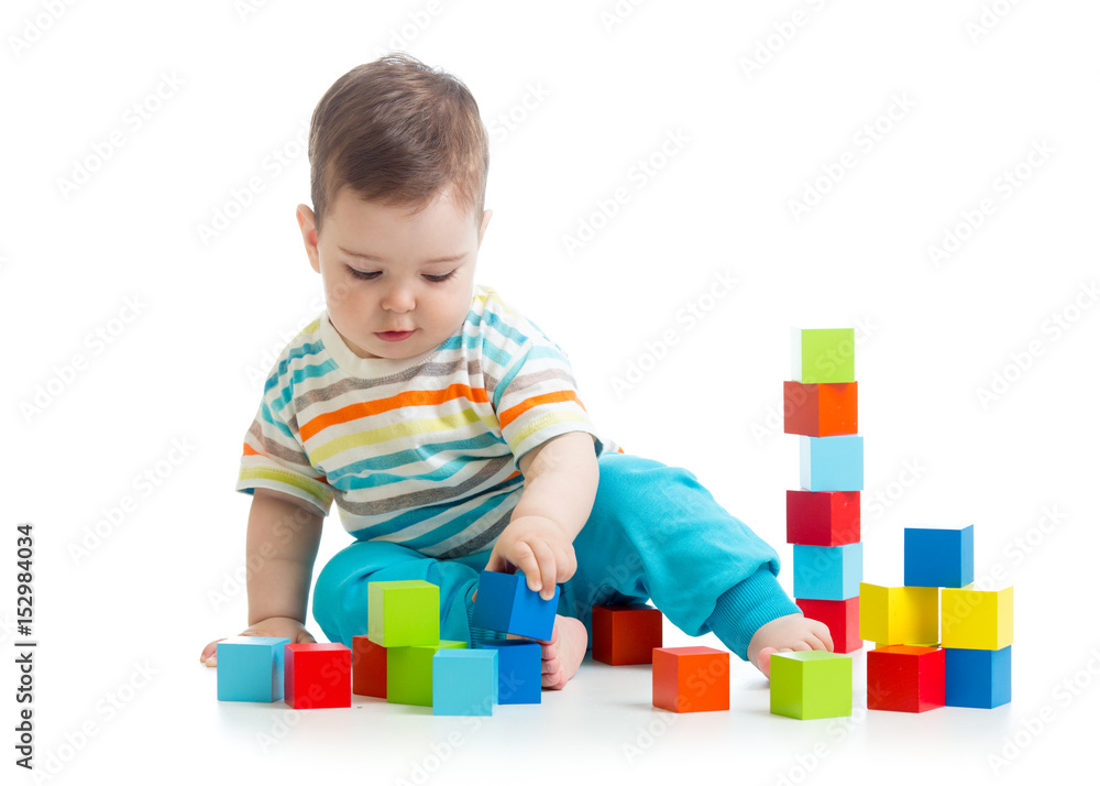 Lovely toddler baby playing with building cubes. Isolated on white. Lovely toddler baby playing with building cubes. Isolated on white.