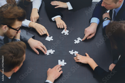 business team solving puzzle together