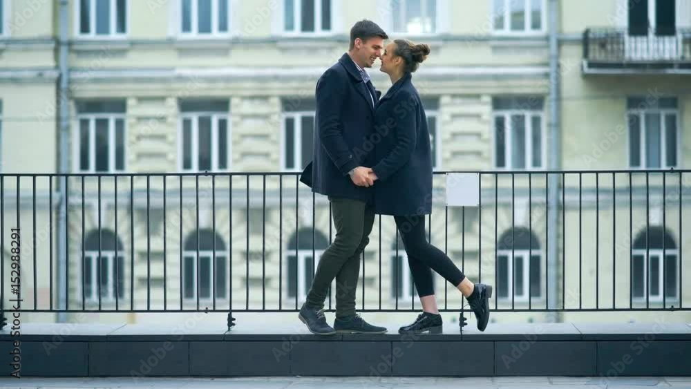 Attractive fashion couple in love posing on the street. Attractive fashion couple in love posing on the street.