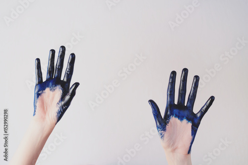 Painted blue hands are give up