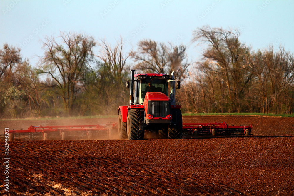 Fototapeta premium Soil preparation with a tractor