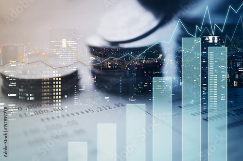 Double exposure of city, graph and rows of coins for finance and banking concept