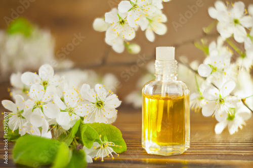 Essence of flowers on table in beautiful glass jar