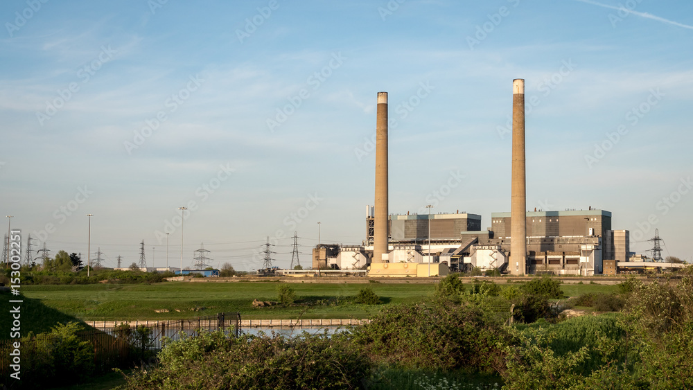 Tilbury Power Stations. The decommissioned coal power stations with pylons behind feeding energy into the UK National Grid electricity network.