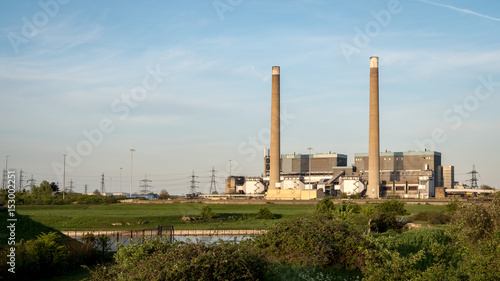 Tilbury Power Stations. The decommissioned coal power stations with pylons behind feeding energy into the UK National Grid electricity network.