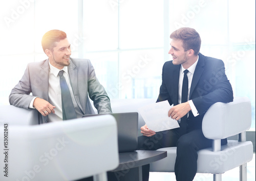 Image of business partners discussing documents