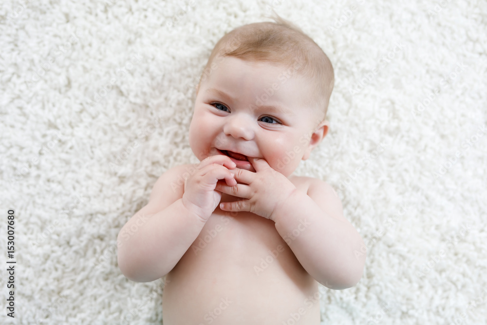 Adorable naked baby girl on white background.