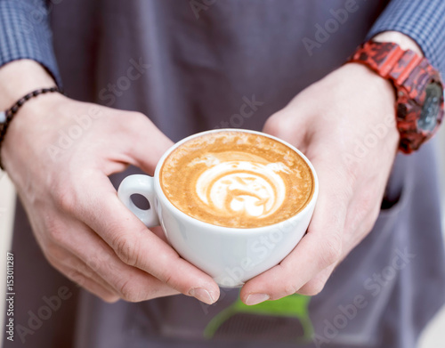 Barista holding coffee