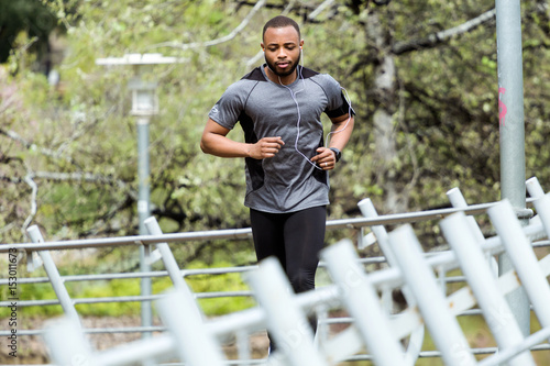 Fit and sporty young man running in the city.