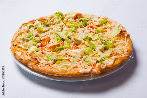 Italian delicious pizza with tomato, lettuce and cheese.