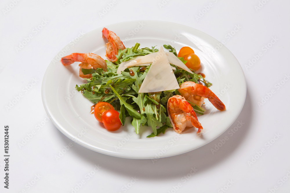 A delicious salad with arugula, cherry tomatoes and shrimps A delicious salad with arugula, cherry tomatoes and shrimps