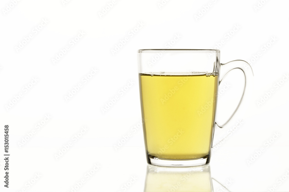 Tea mug with green tea on white isolated background, glass dish for liquids concept Tea mug with green tea on white isolated background, glass dish for liquids concept