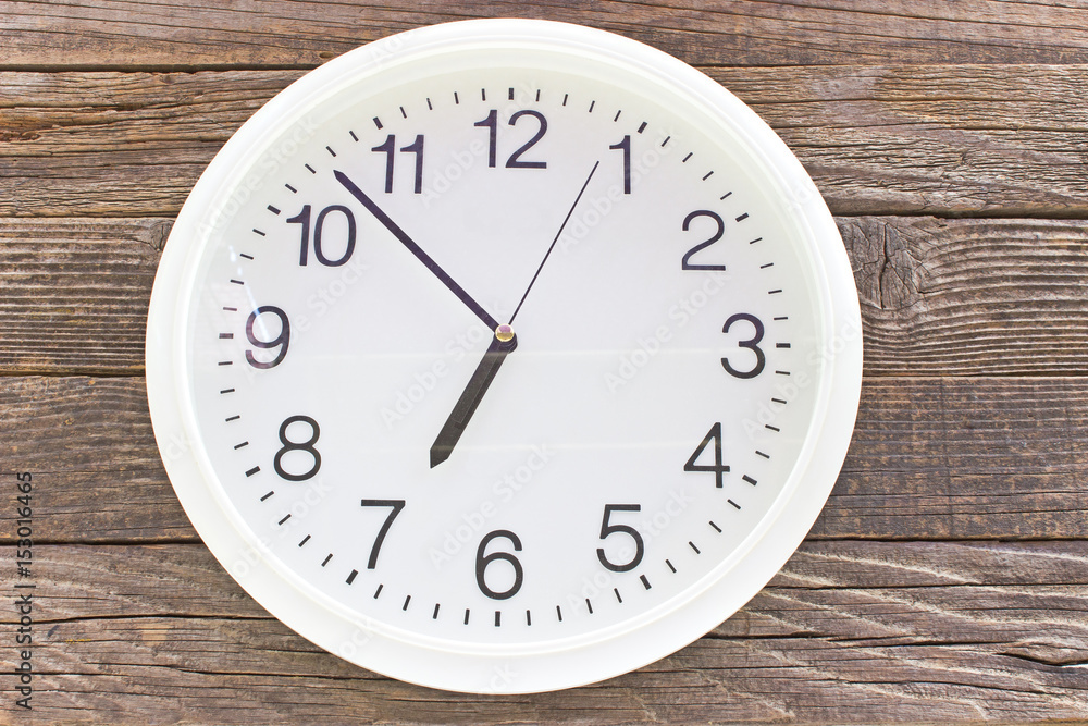 Wall clock on old wooden background Wall clock on old wooden background