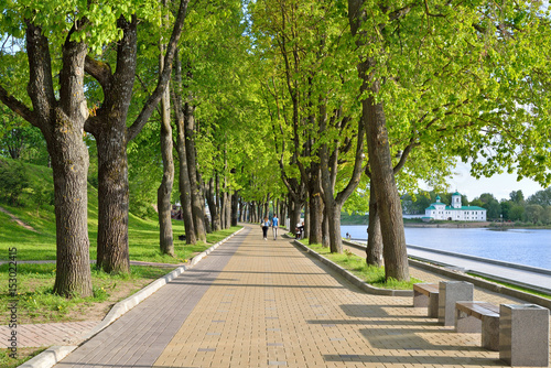 A couple of passersby on the walk of the embankment of the river great