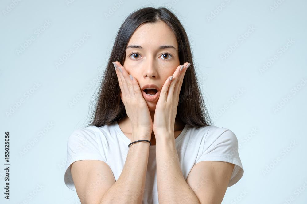 Portrait of a beautiful brunette girl with a surprised look Portrait of a beautiful brunette girl with a surprised look